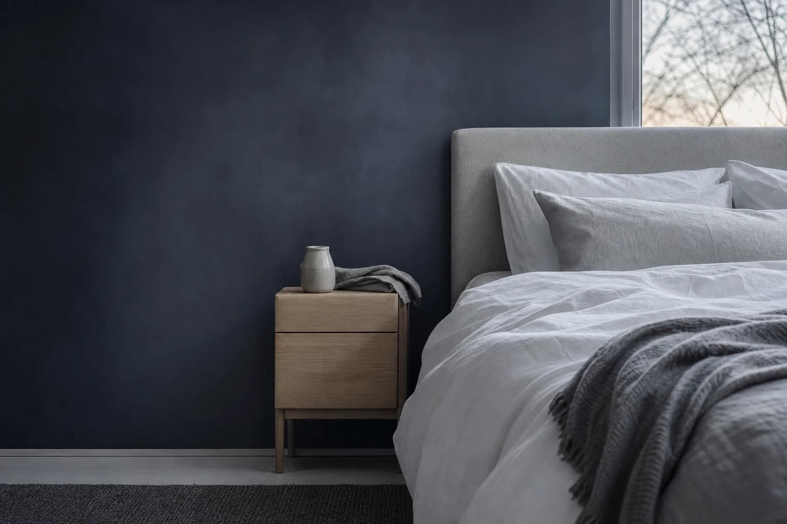 A calm bedroom at dawn with crisp white linen and soft morning light